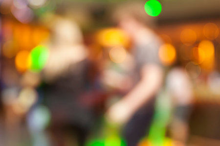 Defocused scene in the night club with bokeh lights and people silhouettesの写真素材