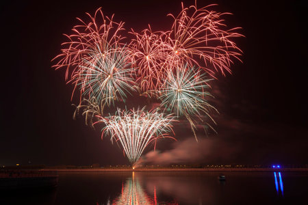 Colourful fireworks exploding over a dark night sky. Festive celebration.