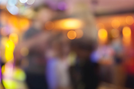 Defocused scene in the night club with bokeh lights and people silhouettesの写真素材