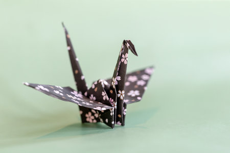 Origami crane on a pale mint backgroundの写真素材