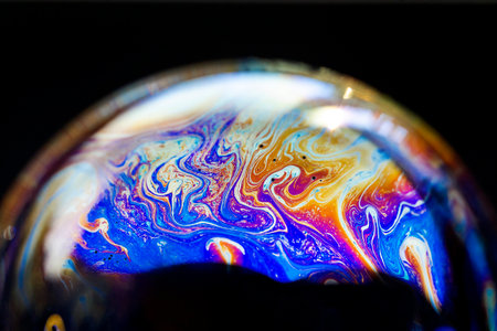 Multicolored abstract chaotic pattern inside of the soap bubble, closeup