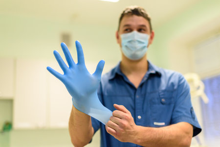 Man dentist Wearing blue gloves.