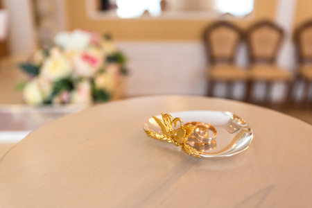 Gold wedding rings on the stand for ringsの写真素材