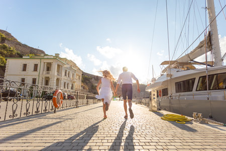 Young couple running oon the pierの写真素材