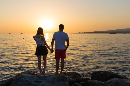 Couple in love see sunset at the beach.の写真素材