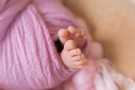 Little sweet legs of newborn baby girlの写真素材