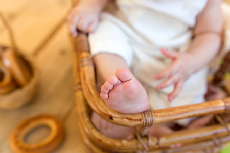 baby girl holding her legsの写真素材