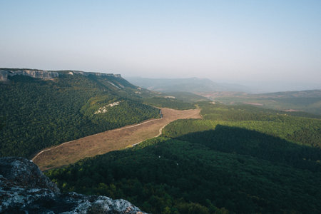 Dramatic landscape of mountains and valley in Crimea. Ancient abandoned mountain town Mangup Kale. Panorama.の写真素材