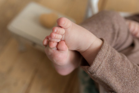Little sweet legs of baby boy on wood backgroundの写真素材