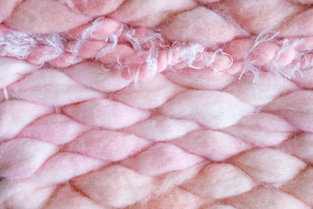 Texture of pink big knit blanket. Large knitting. Plaid merino wool. Top viewの写真素材
