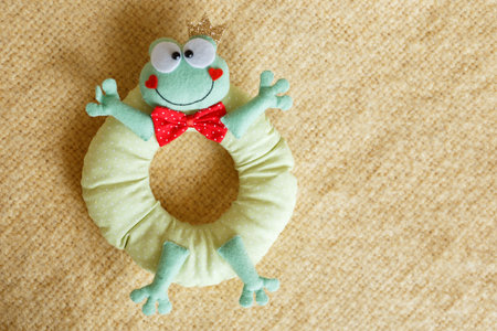 frog soft toy for kids on yellow background.の写真素材