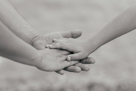 Family concept.Three hands of the family on the tree bark - baby, mother and father. Unity, support,...