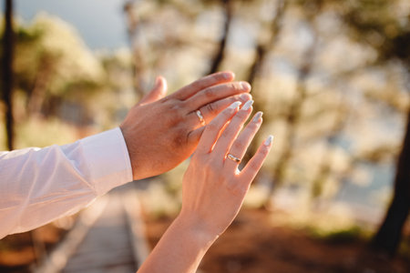Newly wed couple's hands with wedding rings.の写真素材