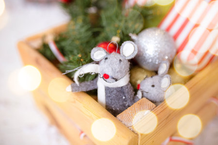 Little mouse toy, symbol of Chinese happy new 2020 in grey dress and new year decoration. Horoscope sign 2020. New Year 's 2020 Symbol. Greeting Christmas card. Front view. Selective focus.の写真素材