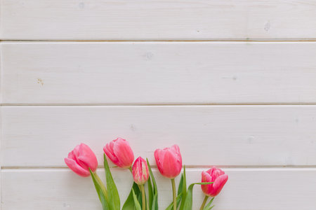 Bouquet of pink tulips on white wooden background. Top view, copy space.の写真素材