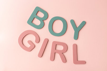 Inscriptions boy girl gender party decoration on the pink background. Horizontal top view.の写真素材