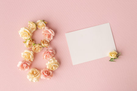 March 8th. Happy Women's Day. Composition in the form of the number eight of rosebuds and white...