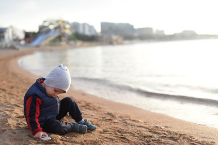 A child playing in the sand by the sea.の写真素材