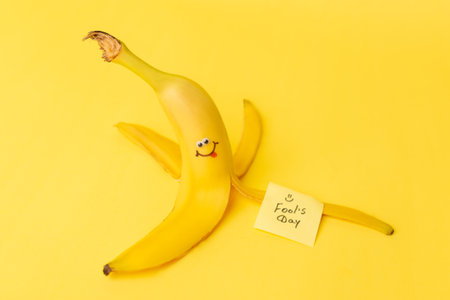 Banana peel with words Fool's Day on the yellow background. April 1st. April Fool's Day.の写真素材