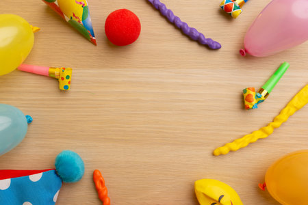 Frame made of different birthday party items on wooden background, flat lay. Space for text.の写真素材