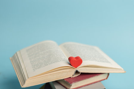 Old vintage books and heart shape wooden piece. world books day. copyspace. education concept.