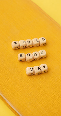Wooden text World Book Day on the yellow texture of vintage book. close-up. education background. World Book Day.の写真素材