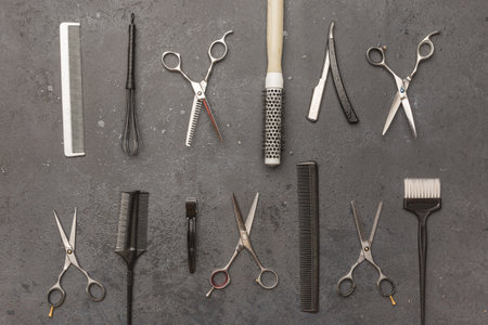 Stylish professional barber scissors, hair cutting shears on black background. Hairdresser salon...