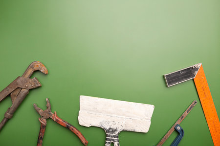 Happy Labor day concept. Different construction tools on green background, with copy space for textの写真素材