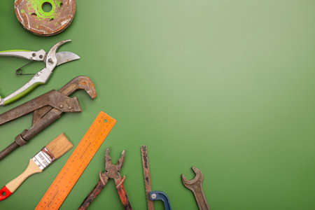 Happy Labor day concept. Different construction tools on green background, with copy space for textの写真素材