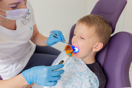 A child boy with a dentist in a dental officeの写真素材