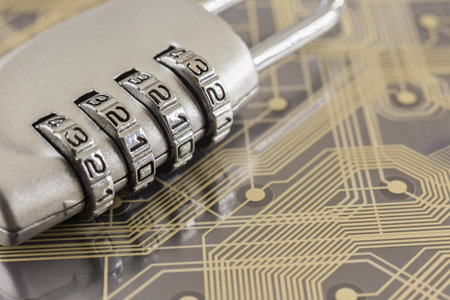 Metal silver padlock with 4 digit combination lock put on plastic digital circuit board, gold line...
