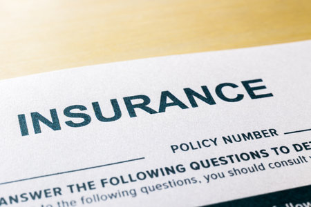 Close up image, selective focus on word INSURNCE, questionnaire and application form on wooden desk background. Healthcare, security, personal safety plan and business invesment concepts.の写真素材