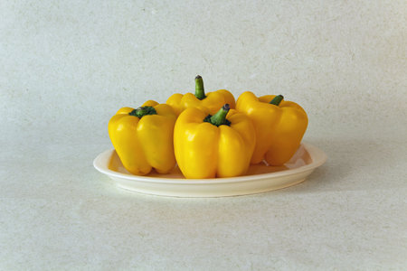 Yellow peppers against light green background