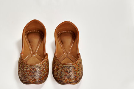 Traditional pure leather footwear (jutti) from India on a white backgroundの写真素材
