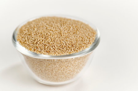 White Poppy Seeds in a glass bowl on a white backgroundの写真素材