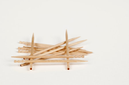 Closeup view of a pile of wooden toothpicks on a white bsckgroundの写真素材