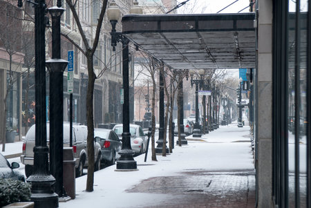 Snow falling on urban side streetの写真素材