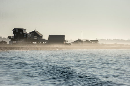 Morning mist drifting across New England beachの写真素材