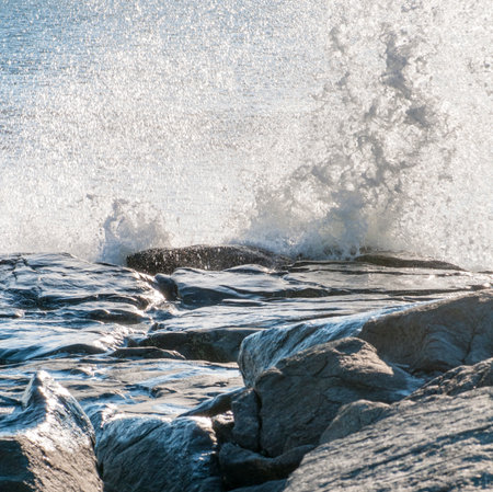 Wave explodes against rocky outcrop on Buzzards Bay