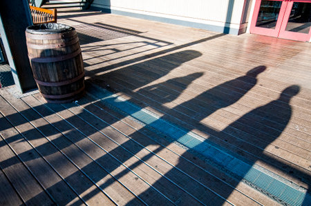 Long shadows of strollers on a late afternoon in winterの写真素材
