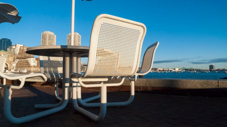 Unoccupied tables along Boston Harborwalk on winter morningの写真素材