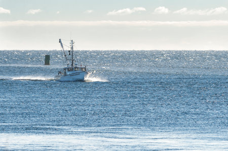 Sandwich, Massachusetts, USA - September 14, 2014: Fishing boat returning from trip on windy Cape Cod Bayのeditorial素材
