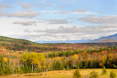 Colorful hills gradually give way to snow-capped mountainsの写真素材
