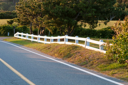 White fence bordering curve on Cape Codの写真素材