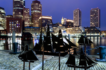 South Boston, Massachusetts, USA - January 26, 2017: Sailing ship artwork on Fan Pier silhouetted against Boston skylineのeditorial素材