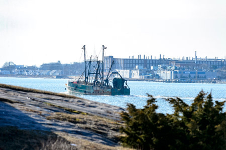 New Bedford, Massachusetts, USA - January 29, 2017: Fishing vessel leaving harbor in New Bedford,...