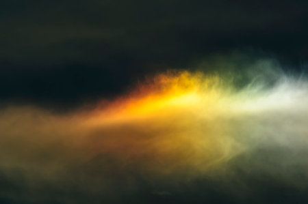 Diffused rainbow created by sun behind thin blanket of clouds
