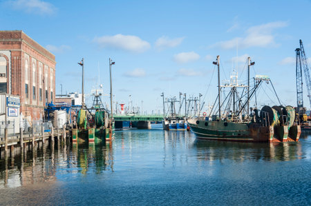 New Bedford, Massachusetts, USA - March 15, 2017: Fishing vessel easing toward dock on New Bedford waterfrontのeditorial素材