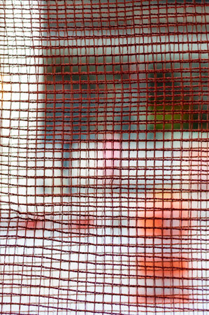 New York street through rusting wire meshの写真素材