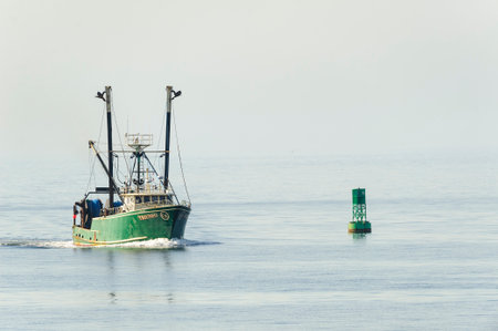 New Bedford, Massachusetts, USA - April 12, 2017: Fishing vessel Trifuno approaching New Bedford on hazy morningのeditorial素材